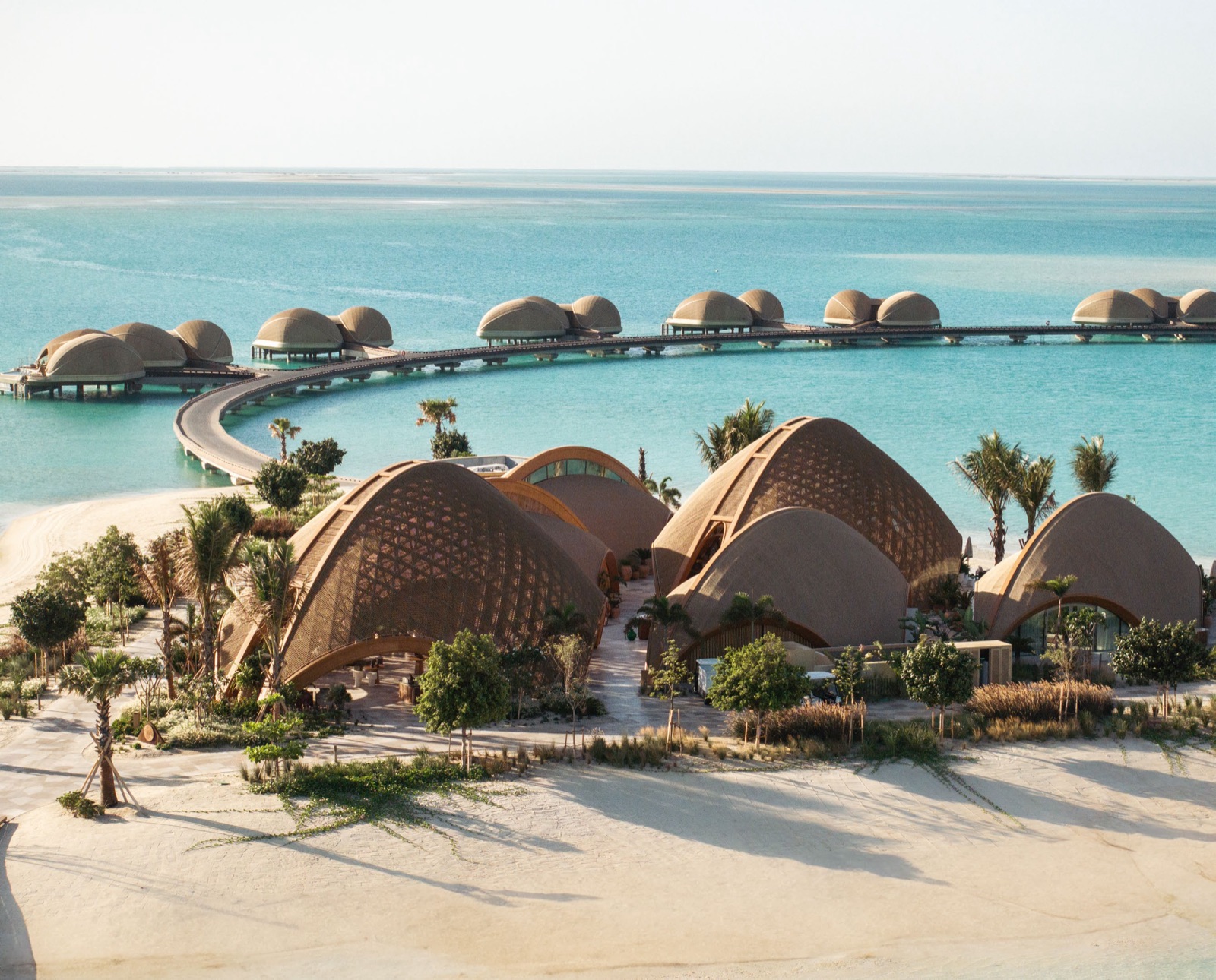 Dune-inspired dome villas along a white-sand Red Sea beach
